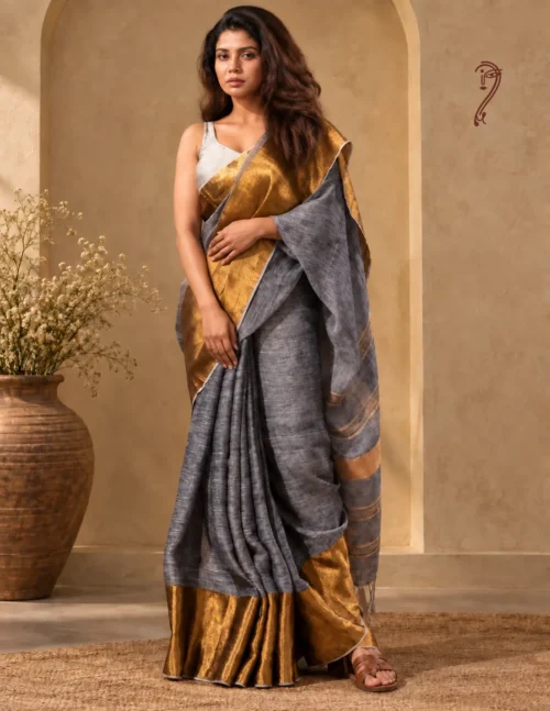 Grey linen saree with golden zari border worn by model