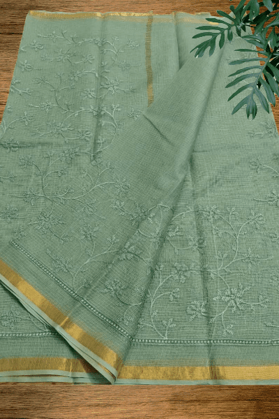 Green Kota cotton saree with floral embroidery and golden zari border from Mridula