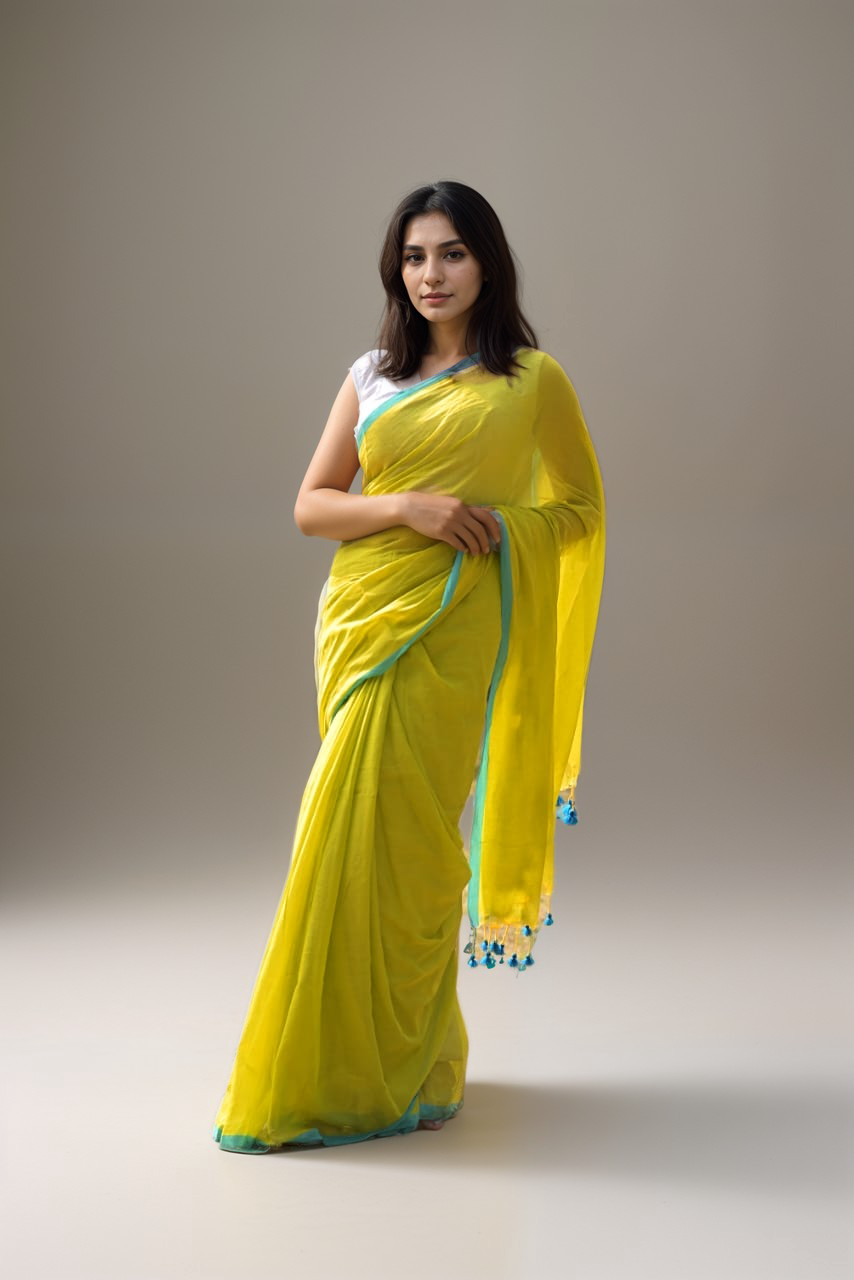 Woman wearing Mridula lime green mul cotton saree with blue tassels