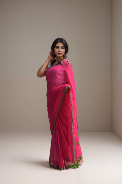 Woman in pink mul cotton saree with olive green border from Mridula