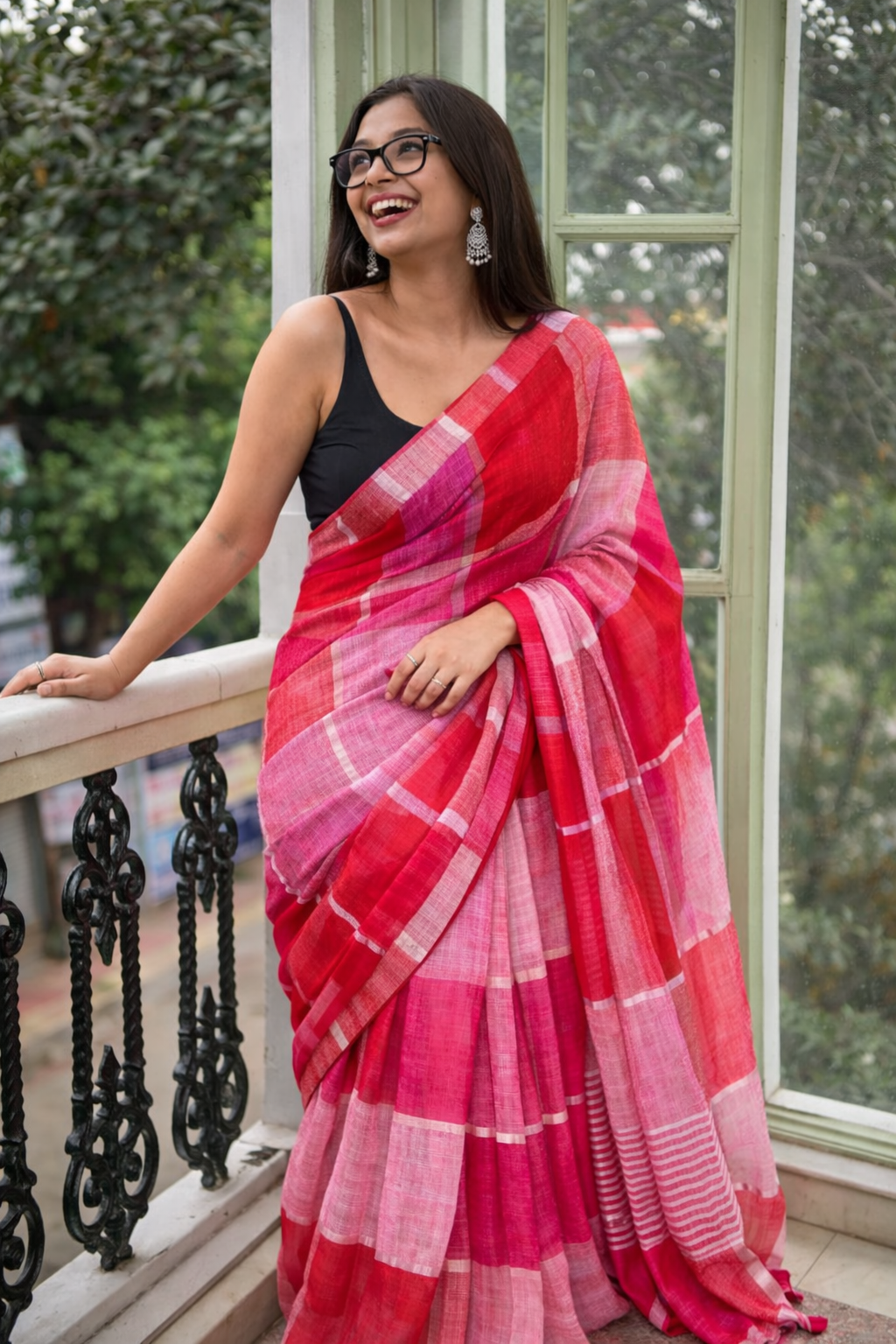 Model wearing Bahaar multicolour cotton linen saree with soft pastel boxes, styled casually in a café setting