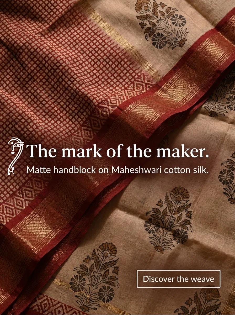 Close-up of maroon checks Maheshwari cotton silk fabric with zari border and floral handblock print