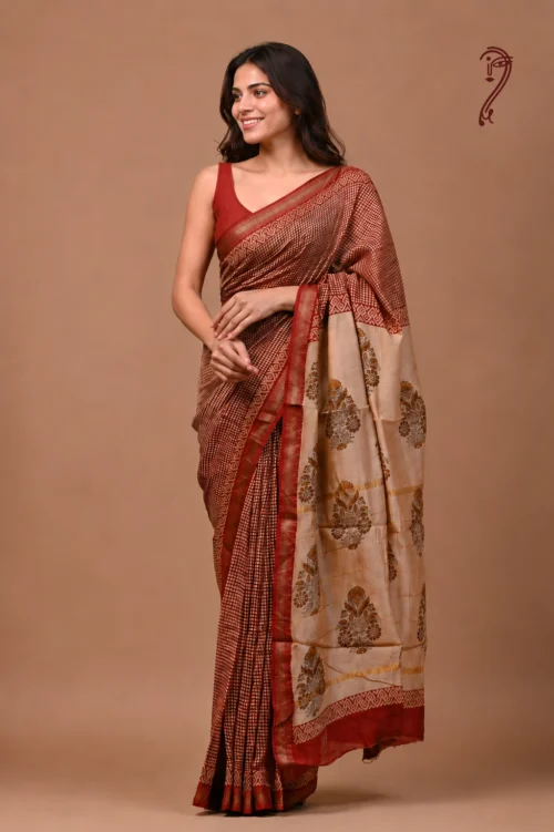 Woman wearing maroon checks Maheshwari cotton silk saree with floral beige pallu